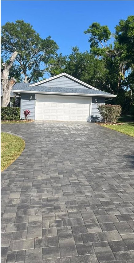 The same paver driveway with color restored after cleaning and sealing